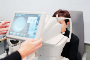 Image of an ophthalmologist performing an eye checkup on an elderly female patient using bladeless LASIK.